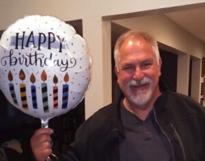 The man with his birthday balloon.
